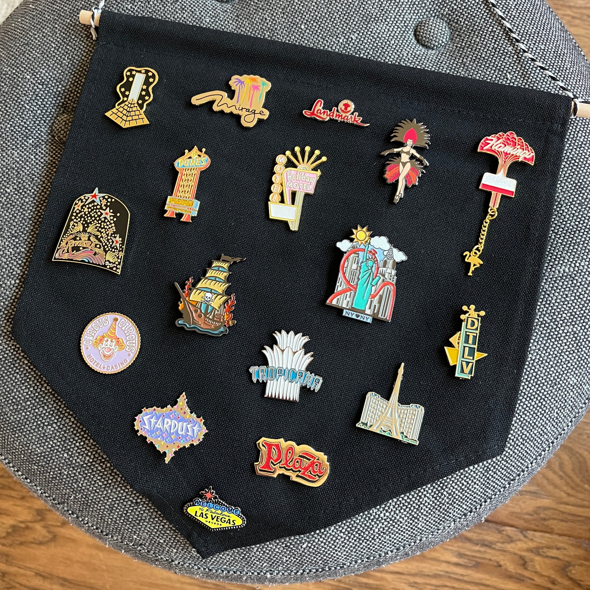 Collection of colorful Las Vegas-themed pins on a black background